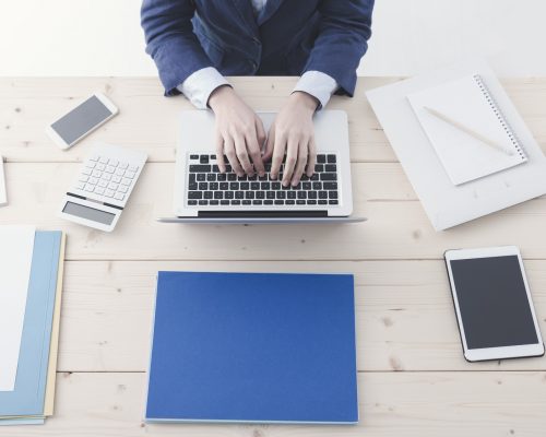 office-worker-typing-on-a-laptop-76ZKHEY.jpg